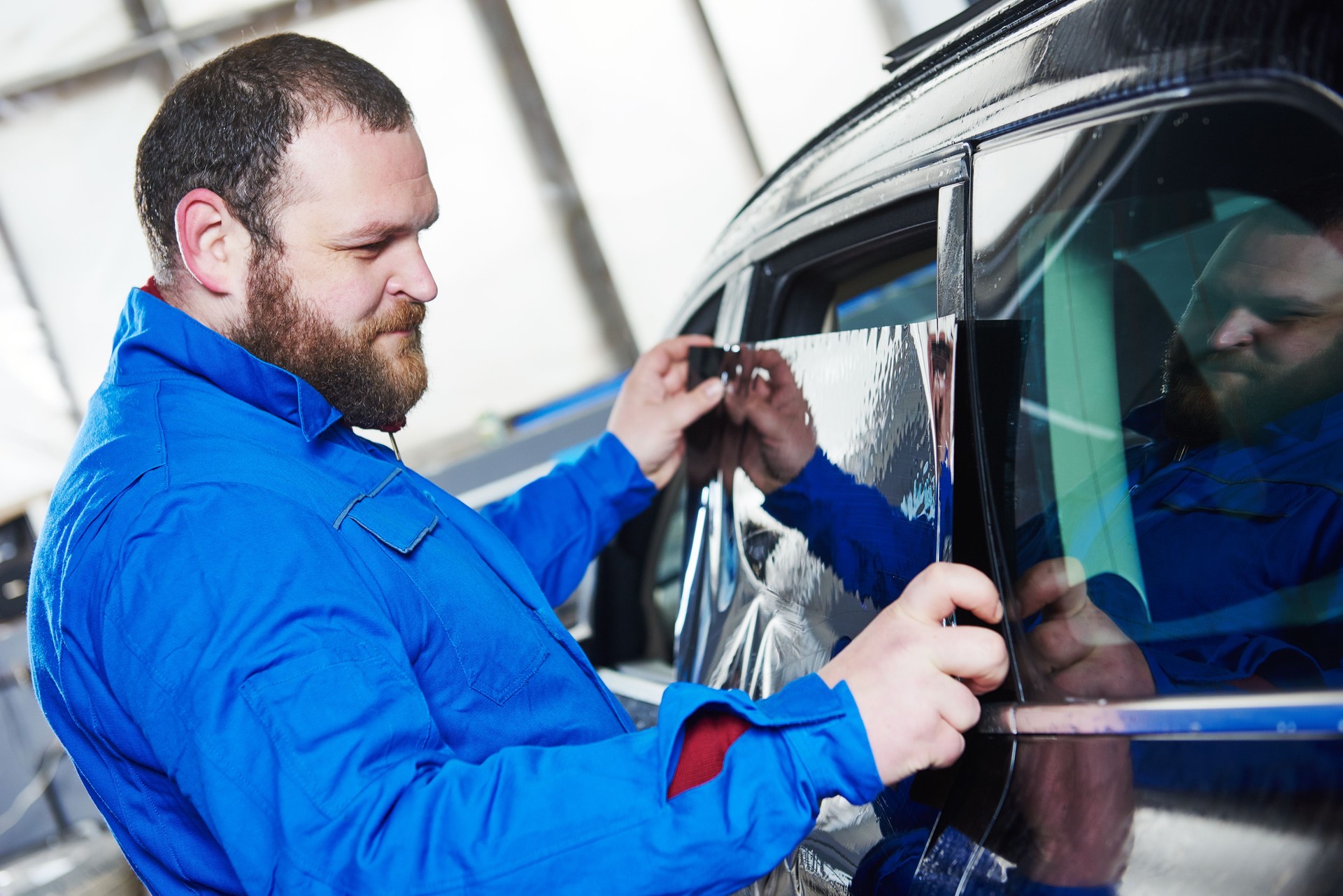 car tinting. Automobile mechanic technician applying foil