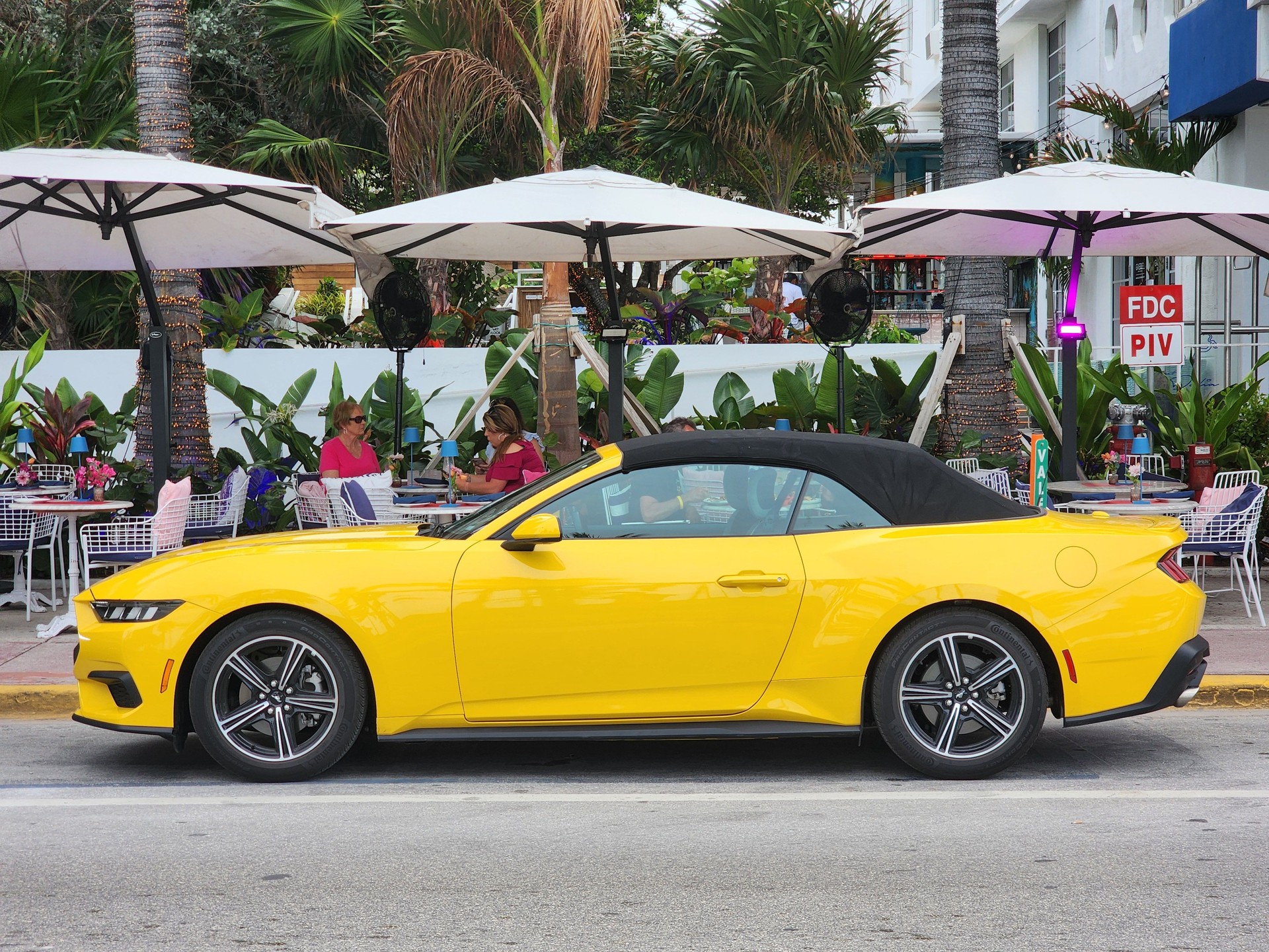 Ford Mustang EcoBoost yellow at ocean drive Miami beach. Ford mustang is a classic american muscle car